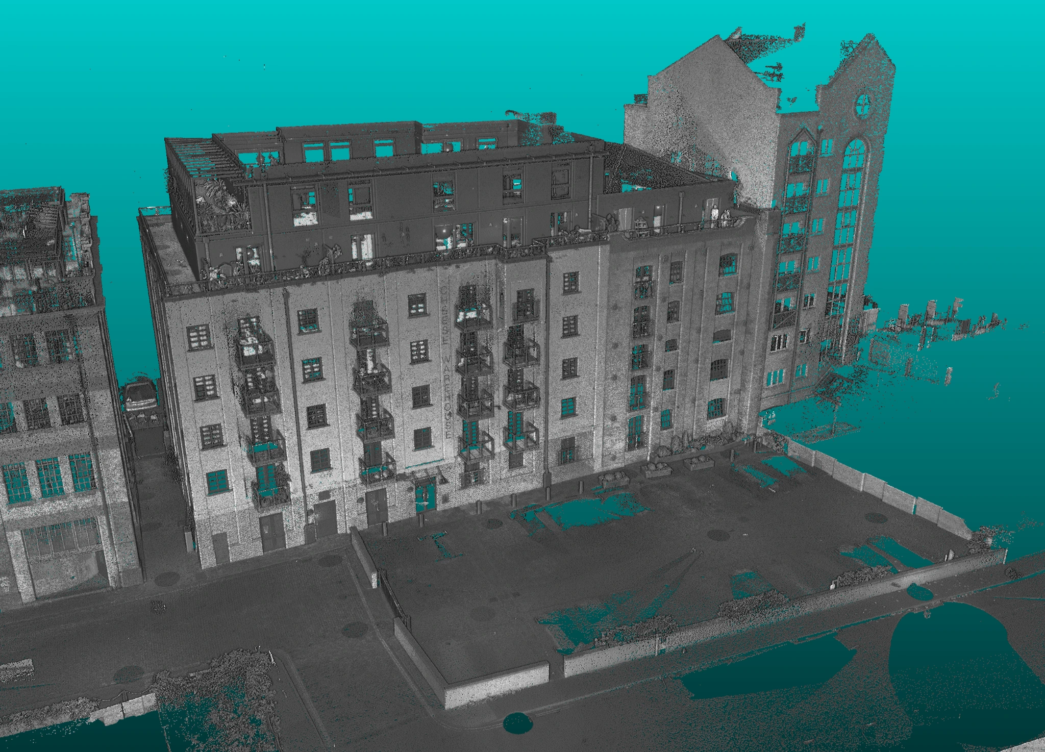 Greyscale production point-cloud view of the Cheese Warehouse façade, showing windows, balconies and the canal-side bridge.