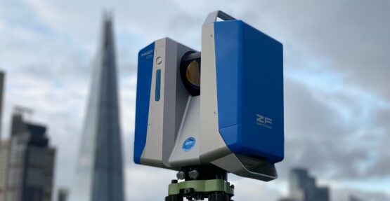 A 3D laser scanner on a tripod with the London skyline in the background, capturing architectural details